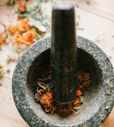 Discover the natural healing power with this mortar and pestle filled with dried herbs.